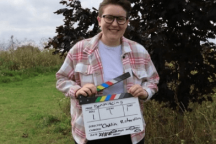 Person holding clapperboard