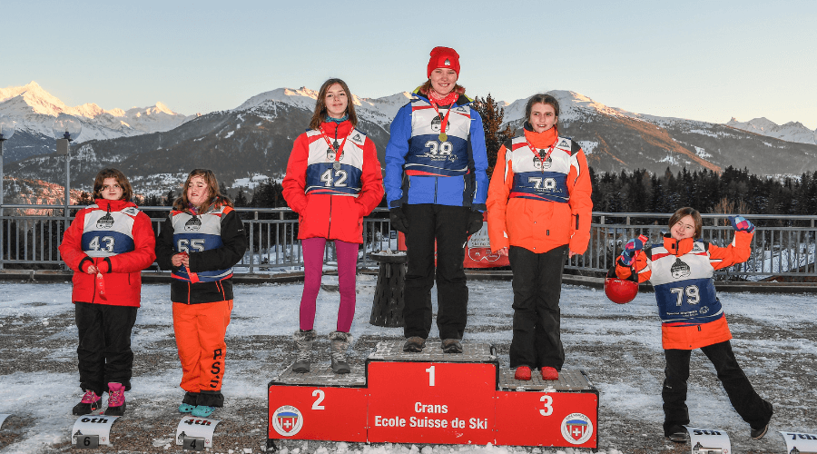 standing on a podium at special Olympics skiing event